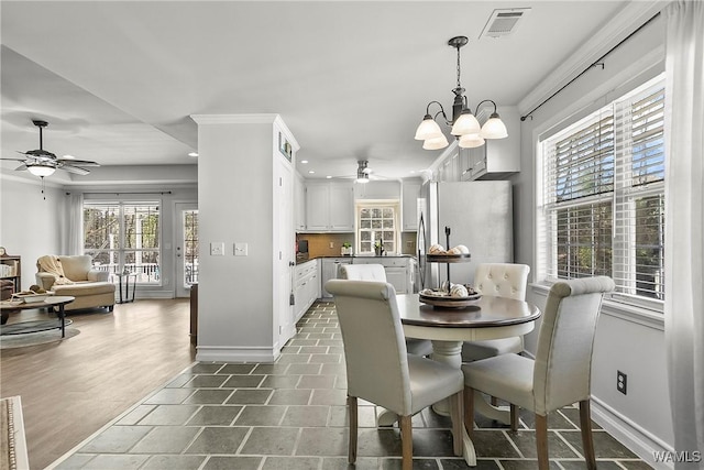 dining room with recessed lighting, ceiling fan with notable chandelier, visible vents, baseboards, and crown molding