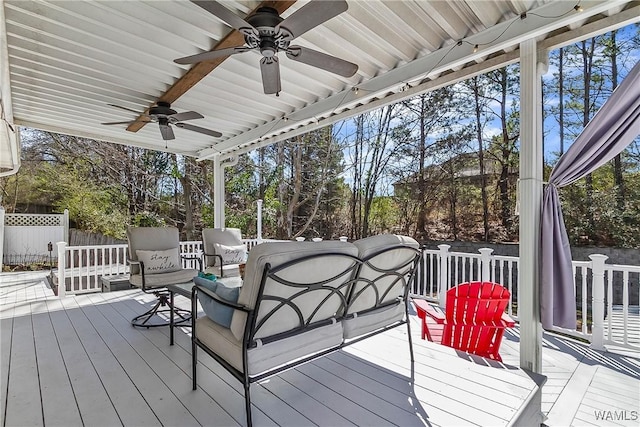 wooden deck with fence and a ceiling fan