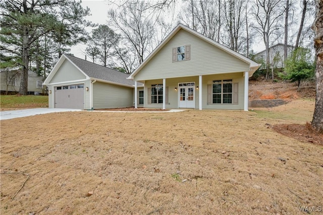 view of front of property featuring a garage, a porch, and concrete driveway