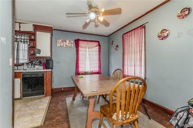 dining room with dark hardwood / wood-style flooring, ceiling fan, and a healthy amount of sunlight