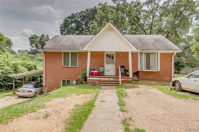 view of front facade with covered porch and a carport