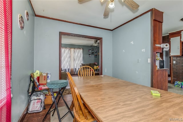dining room featuring light wood-type flooring and crown molding