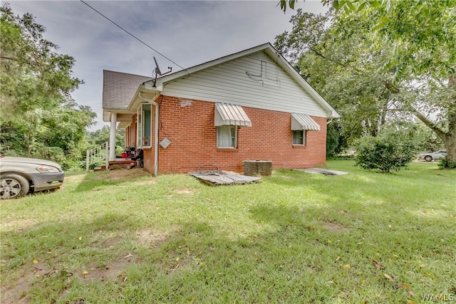 rear view of property featuring a yard