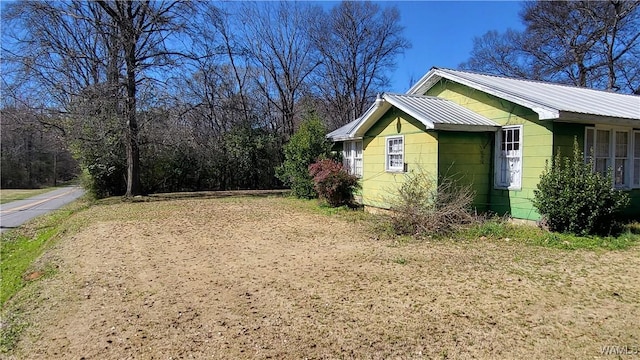 view of property exterior with metal roof