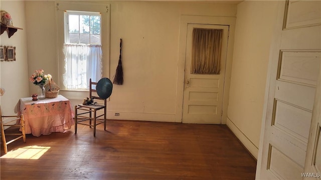 interior space featuring baseboards and wood finished floors