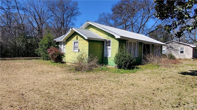 view of property exterior featuring metal roof