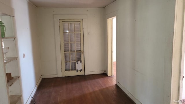 hall with dark wood finished floors and baseboards