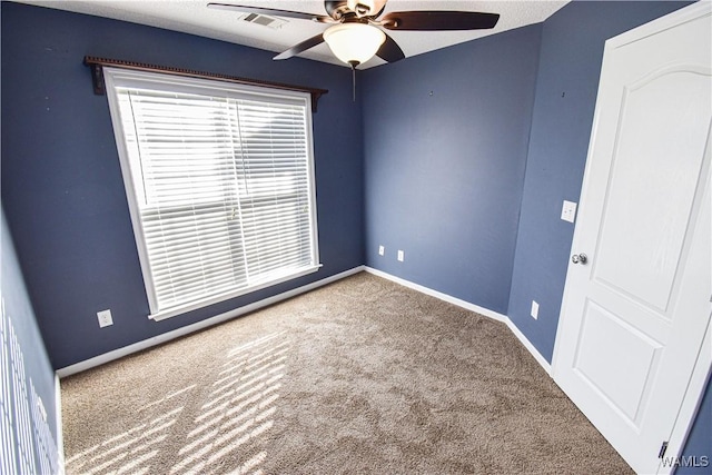 empty room with ceiling fan and carpet floors