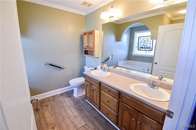 bathroom featuring a washtub, toilet, wood-type flooring, and crown molding