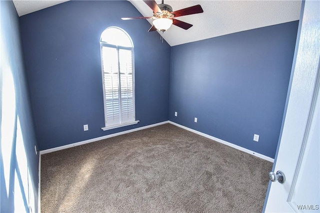 carpeted empty room featuring a textured ceiling, ceiling fan, and lofted ceiling