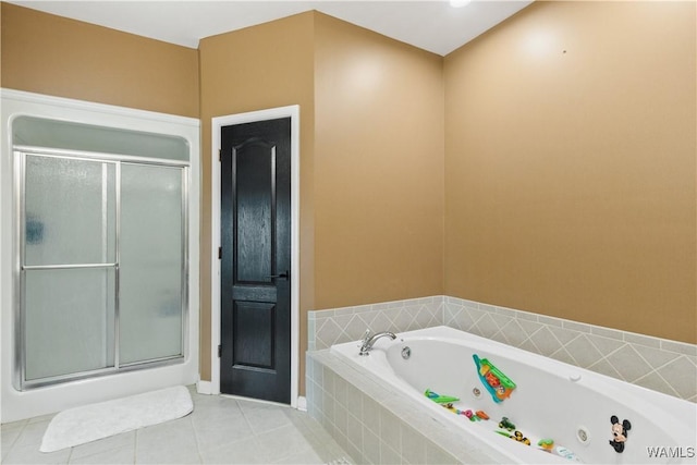 full bathroom featuring tile patterned flooring, a stall shower, a jetted tub, and baseboards