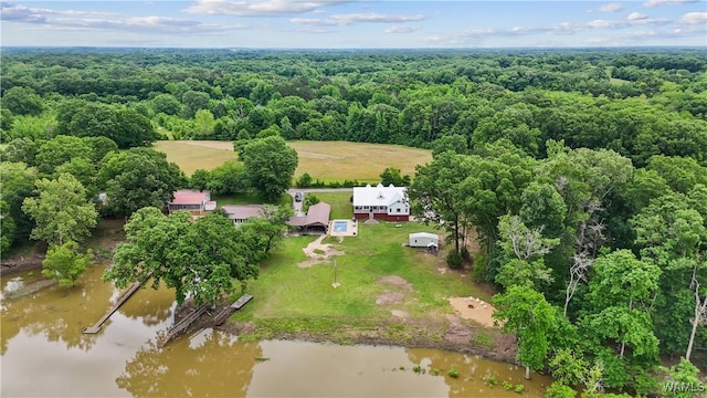 aerial view of a heavily wooded area and a nearby body of water
