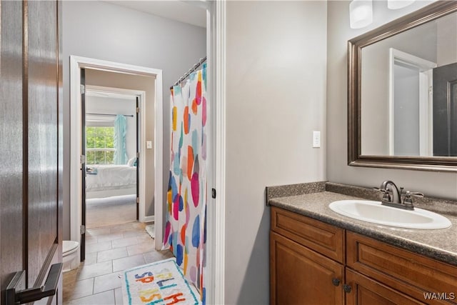 bathroom with vanity, tile patterned floors, ensuite bath, baseboards, and a shower with curtain