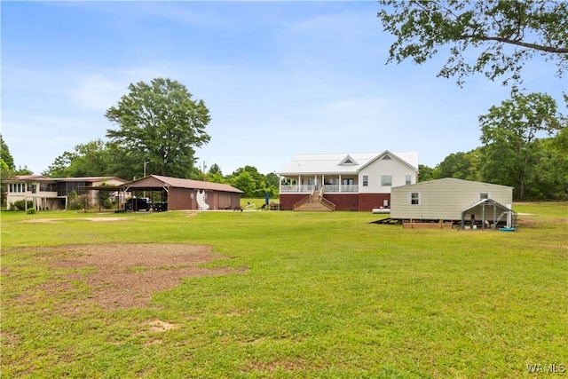 view of grassy yard with a carport and stairway