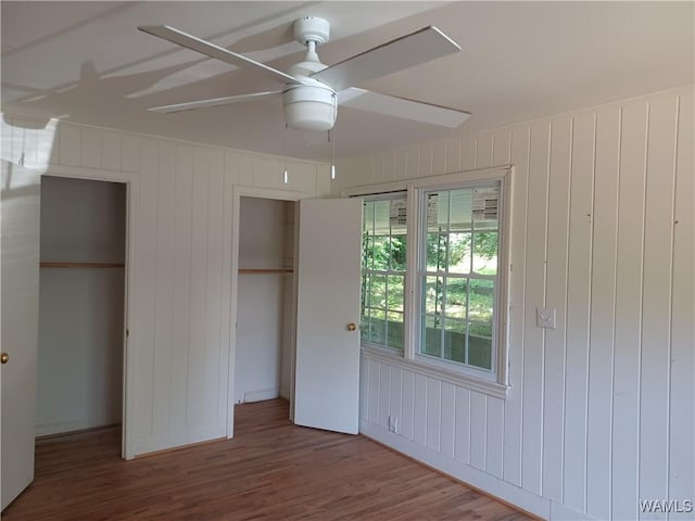 unfurnished bedroom with wood finished floors and a ceiling fan
