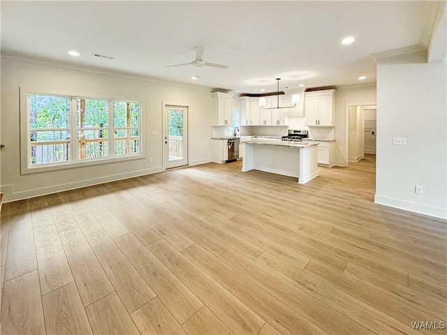 8 Northside Rd, Berry, AL 35546 - kitchen with ornamental molding, open floor plan, white cabinets, baseboards, and light countertops