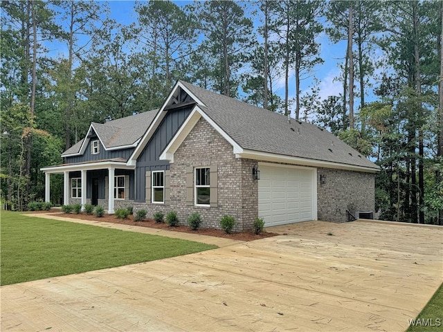 8 Northside Rd, Berry, AL 35546 - view of front of property with board and batten siding, a garage, concrete driveway, a front lawn, and brick siding