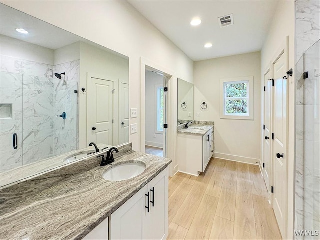 8 Northside Rd, Berry, AL 35546 - bathroom with a marble finish shower, wood finished floors, two vanities, baseboards, and recessed lighting