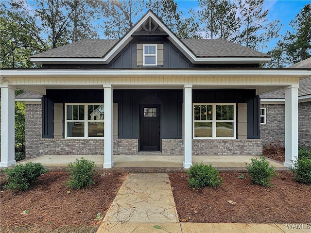 8 Northside Rd, Berry, AL 35546 - view of front of property with a porch, board and batten siding, a shingled roof, and brick siding