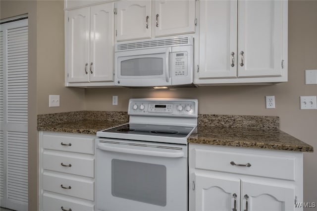 kitchen with white cabinets, white appliances, and dark stone countertops