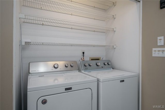 clothes washing area featuring washing machine and clothes dryer