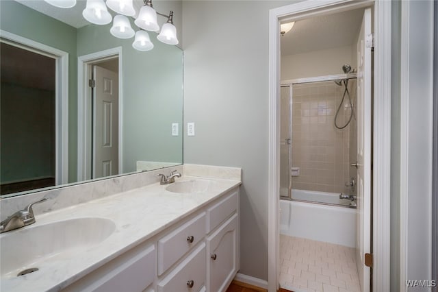 bathroom featuring vanity, a textured ceiling, and enclosed tub / shower combo