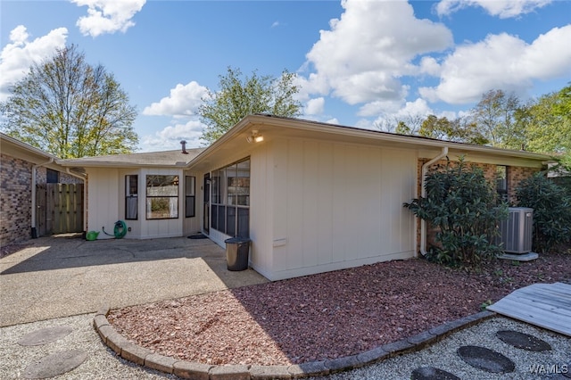 view of side of home featuring central AC unit and a patio area