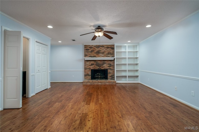 unfurnished living room with a textured ceiling, dark hardwood / wood-style floors, and a brick fireplace