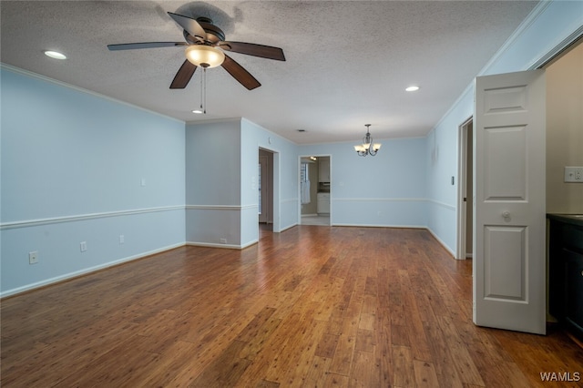 empty room featuring hardwood / wood-style flooring, ceiling fan with notable chandelier, ornamental molding, and a textured ceiling