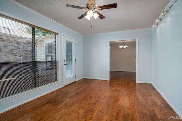 spare room featuring hardwood / wood-style flooring, ceiling fan with notable chandelier, crown molding, and a textured ceiling