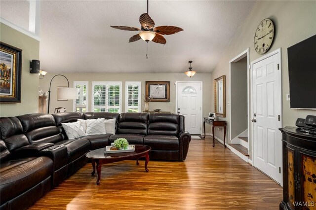 1428 Plymouth Ln, Tuscaloosa, AL 35406 - living area with wood finished floors, vaulted ceiling, a ceiling fan, and stairway