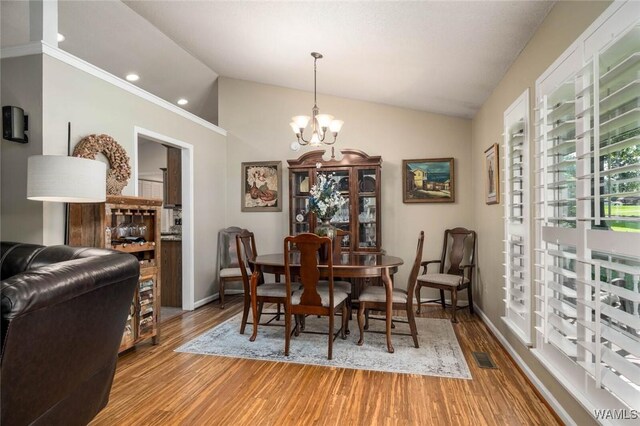 1428 Plymouth Ln, Tuscaloosa, AL 35406 - dining space with a chandelier, wood finished floors, lofted ceiling, and recessed lighting