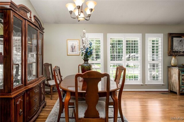 1428 Plymouth Ln, Tuscaloosa, AL 35406 - dining room featuring a chandelier and dark wood-style flooring