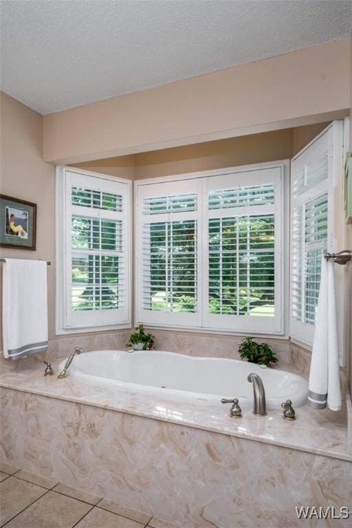 1428 Plymouth Ln, Tuscaloosa, AL 35406 - bathroom with a bath, tile patterned flooring, and a textured ceiling