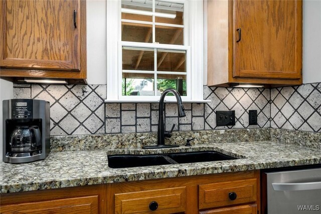 1428 Plymouth Ln, Tuscaloosa, AL 35406 - kitchen featuring dishwasher, brown cabinetry, decorative backsplash, and stone counters