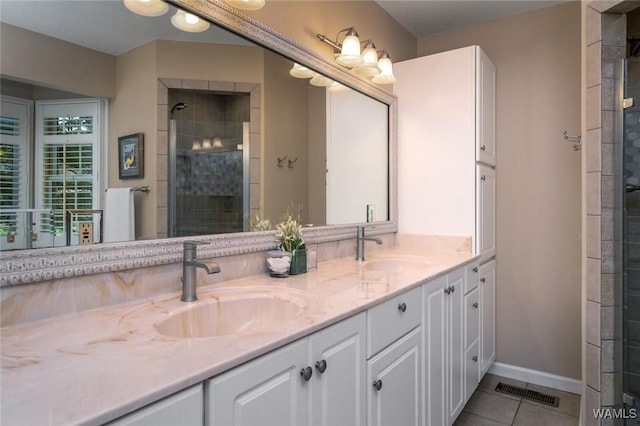 1428 Plymouth Ln, Tuscaloosa, AL 35406 - bathroom featuring double vanity, tile patterned floors, and a shower stall
