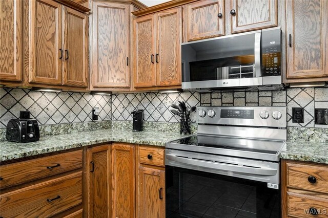 1428 Plymouth Ln, Tuscaloosa, AL 35406 - kitchen featuring stainless steel appliances, brown cabinets, and tasteful backsplash