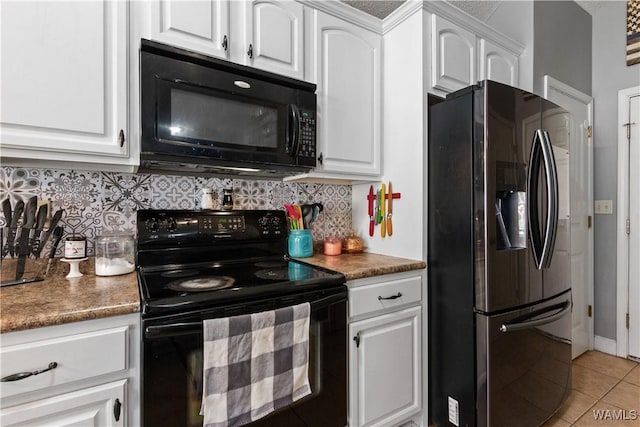 kitchen with black appliances, white cabinetry, light tile patterned floors, and tasteful backsplash