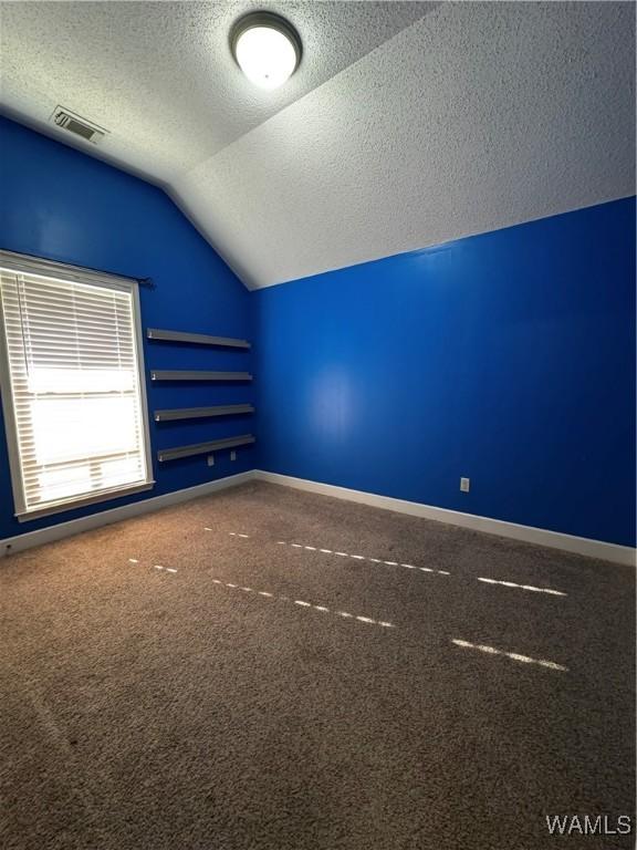 carpeted bedroom featuring ceiling fan and vaulted ceiling