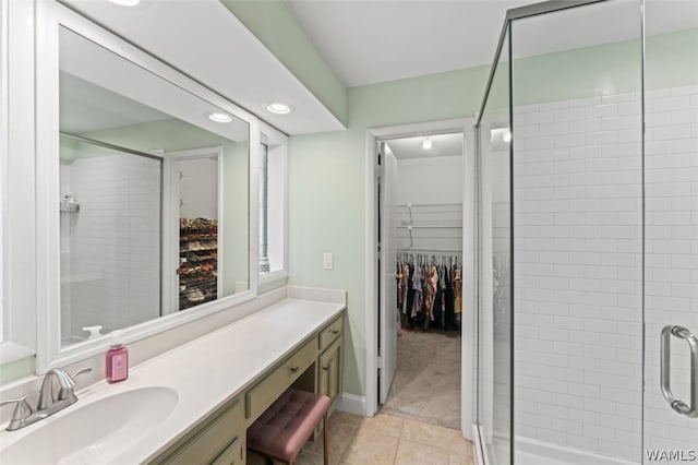 bathroom featuring vanity, tile patterned floors, and a shower with shower door