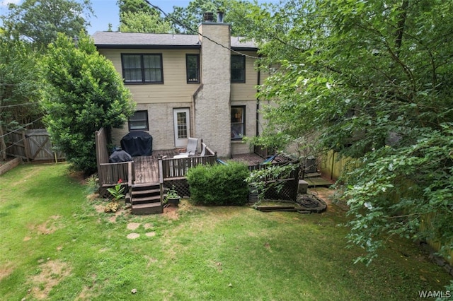 rear view of house with a lawn and a wooden deck