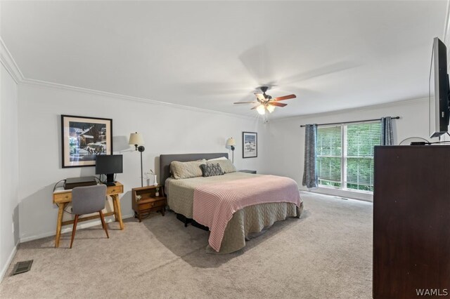 carpeted bedroom featuring ceiling fan and ornamental molding