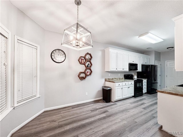 1902 45th Ave, Northport, AL 35476 - kitchen featuring light wood-style flooring, white cabinetry, black appliances, a textured ceiling, and baseboards