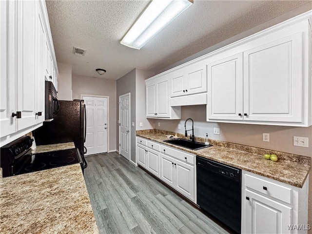 1902 45th Ave, Northport, AL 35476 - kitchen featuring light wood-style flooring, a sink, visible vents, white cabinets, and black appliances