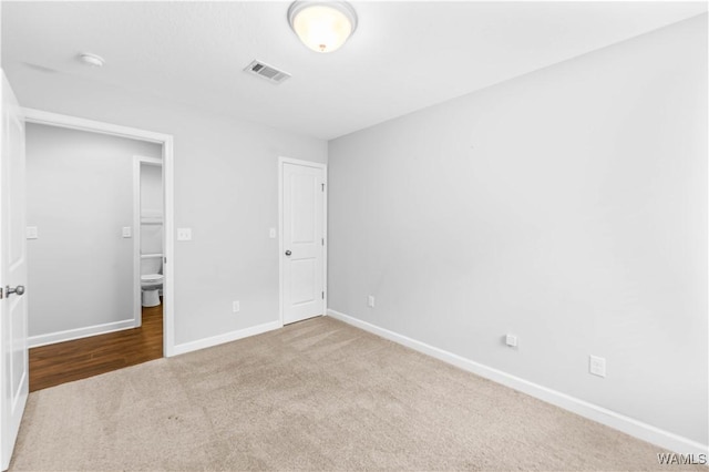 unfurnished bedroom featuring baseboards, visible vents, and carpet flooring