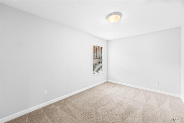 empty room with carpet flooring and baseboards