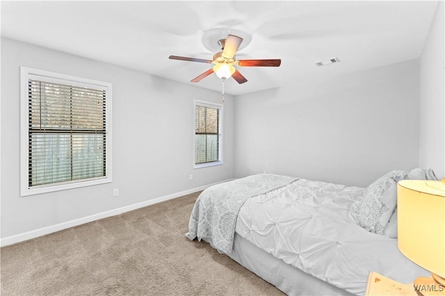 bedroom with carpet floors, visible vents, ceiling fan, and baseboards