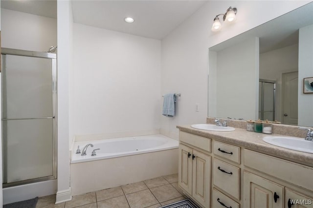 bathroom featuring vanity, shower with separate bathtub, and tile patterned flooring