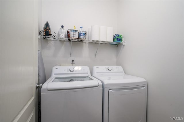 washroom with independent washer and dryer