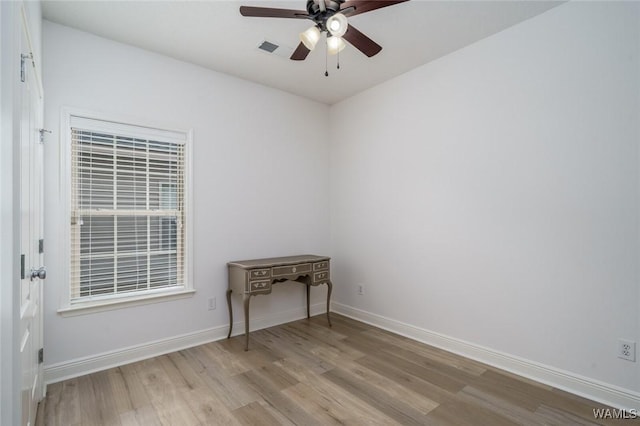 empty room featuring ceiling fan and light hardwood / wood-style flooring